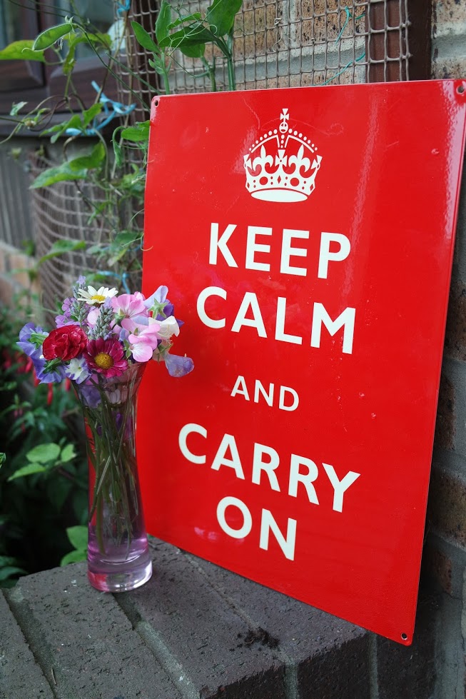 Red keep calm and carry on sign pink vase flowers